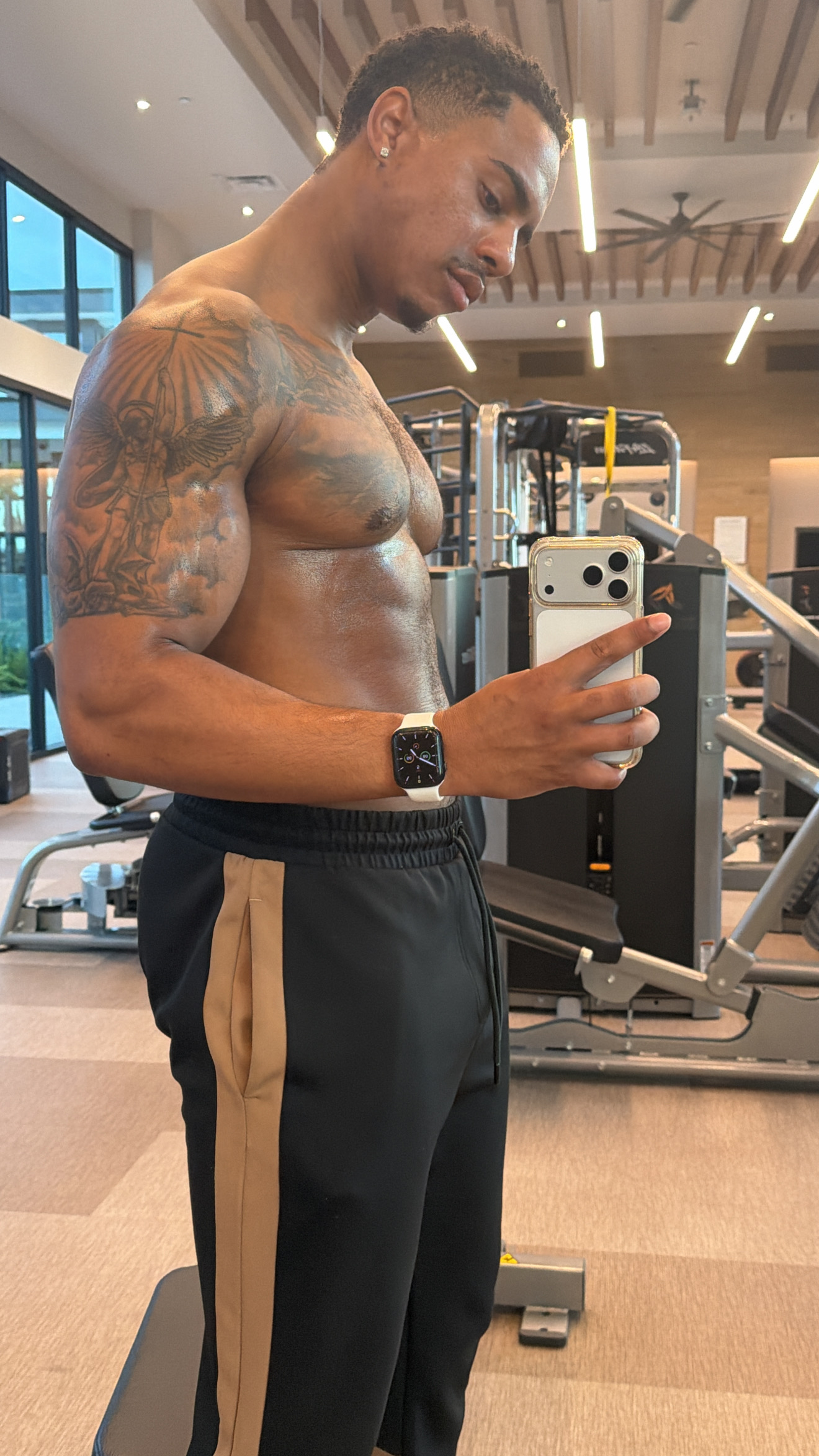 Elijah taking a gym progress photo